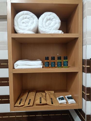 a wooden shelf with towels and towels at Hotel Shiny Grand in Guwahati