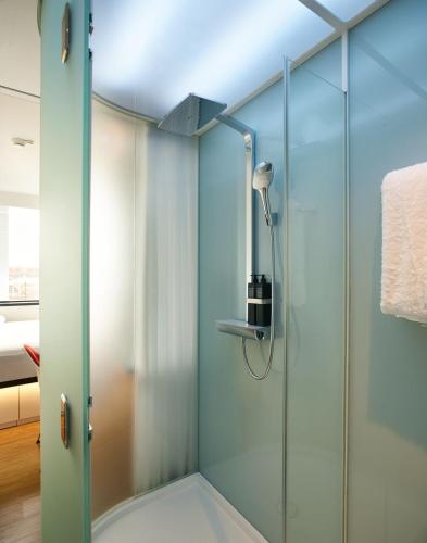 a shower with a glass door in a bathroom at citizenM Chicago Downtown in Chicago