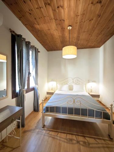 a bedroom with a bed with a wooden ceiling at John & Mary's House near Elafonisi Beach in Perivólia