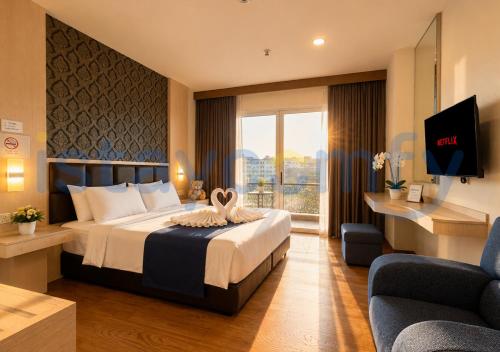 a hotel room with a bed and a tv at Studio Aston Residence 0306 City View in Nagoya
