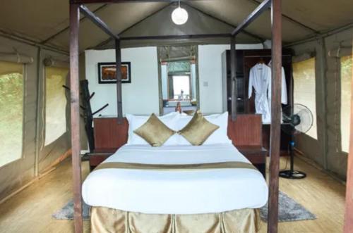 a bedroom with a bed in a tent at La Maison Mara in Ololaimutiek