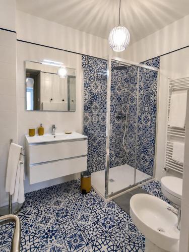 a blue and white bathroom with a shower and a sink at B&B da Cencia in Monte San Biagio