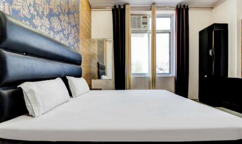 a large white bed in a room with a window at hotel shivay in Basti