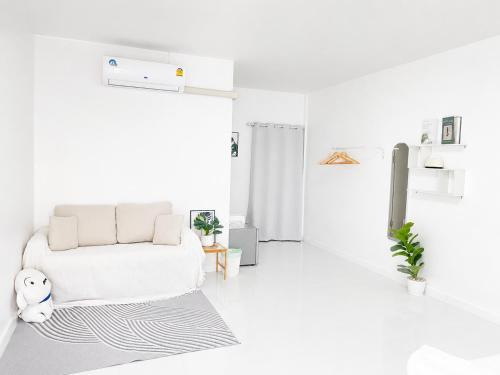 Ein weißes Wohnzimmer mit Sofa und Teppich in der Unterkunft Seamsak hotel in Golden Triangle