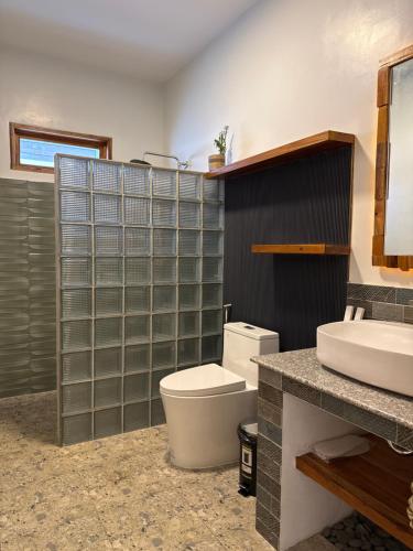 a bathroom with a toilet and a sink at Bella Napoli Resort & Resto in Panglao Island