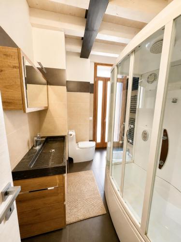 a bathroom with a toilet and a sink and a shower at Palazzo Degli Affreschi - Luxury Villa Verona in Verona