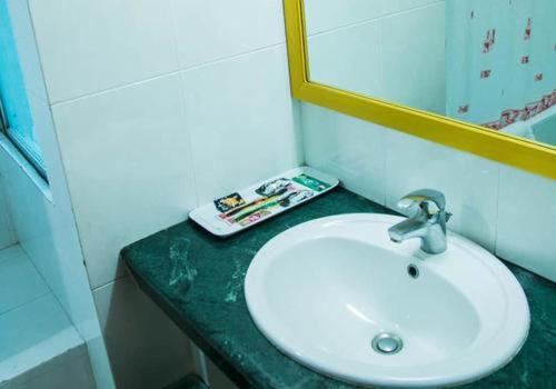 a bathroom with a sink and a mirror at Hotel West Valley - Baridhara in Dhaka