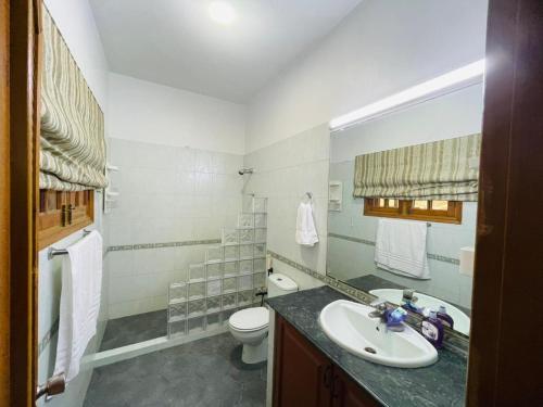 a bathroom with a sink and a toilet at Signature 3 Bed Villa Clifton Boat Basin in Karachi