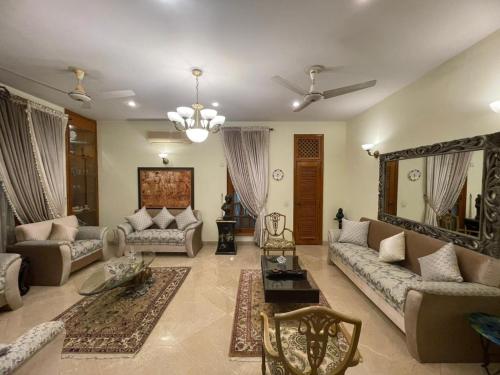 a large living room with couches and a table at Signature 3 Bed Villa Clifton Boat Basin in Karachi