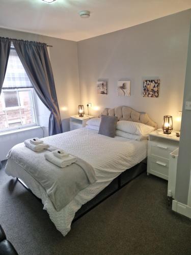 a bedroom with a large bed and a window at The Coastal Inn OUTBUILDING in Cellardyke