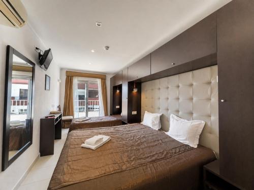 a large bedroom with two beds and a window at Residência São Francisco by Umbral in Fátima