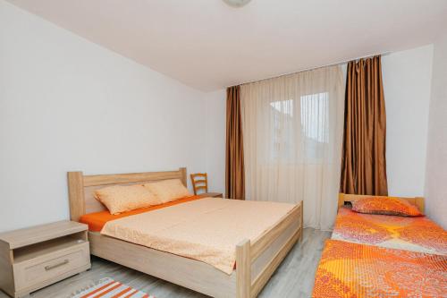 a bedroom with two beds and a window at Stan Vukovic in Bar