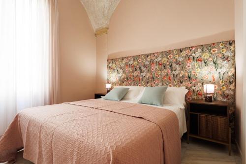a bedroom with a large bed with a colorful wall at Grotta Sancta Suite&SPA in Gallipoli