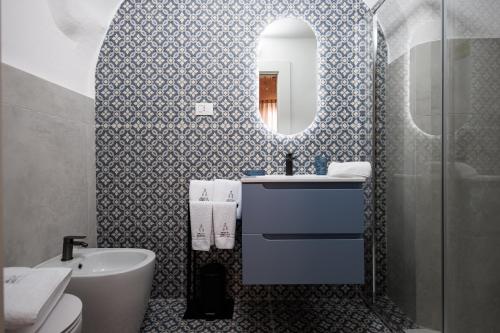 a bathroom with a sink and a mirror at Grotta Sancta Suite&SPA in Gallipoli