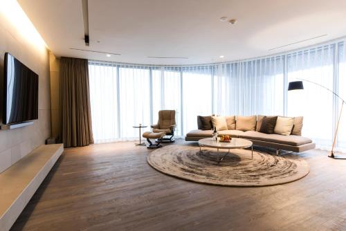 a living room with a couch and a table at Hotel Nanta Jeju in Jeju