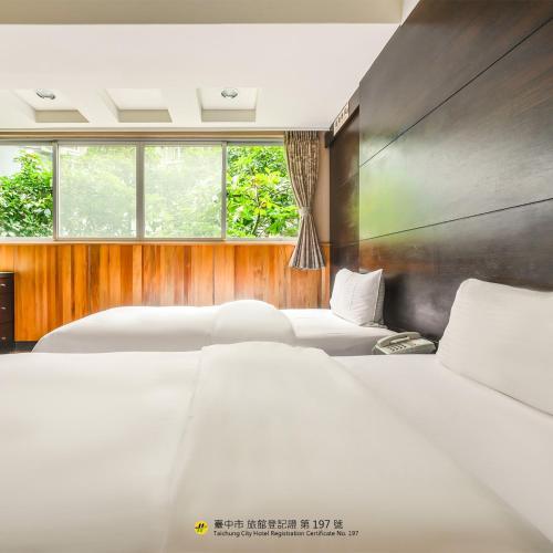 a bedroom with two beds and two windows at CHECK inn Express Taichung Fengchia in Taichung