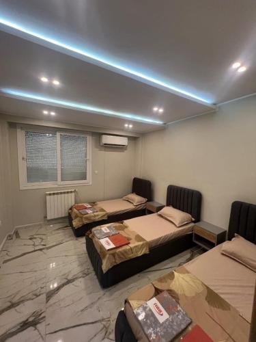 a room with three beds in a room at luxury apartment in Annaba