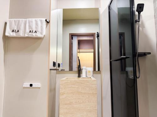 a bathroom with a sink and a mirror at Ala Boutique Hotel in Almaty