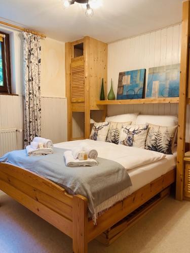 a bedroom with a large bed with towels on it at Waldzauber am See in Clausthal-Zellerfeld