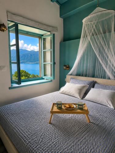 a bedroom with a bed with a window and a table at Chalet Como Lake - Nature Retreat, foot access only in Griante Cadenabbia