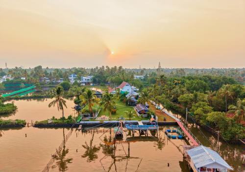 an aerial view of a village on a river at Celestiah Lakeshore Kochi by VOYE HOMES - Peaceful Backwater Stay in Kumbalangi in Cochin
