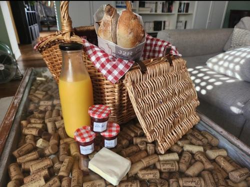 a basket of bread and a bottle of orange juice at Cœur de Toucy in Toucy