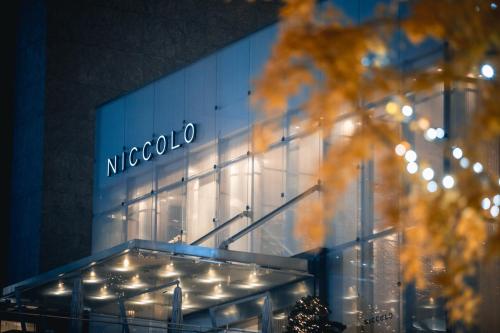 a mecoo building with lights on the side of it at Niccolo Chengdu in Chengdu