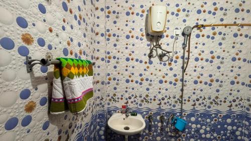 a bathroom with a sink and a towel at Hotel Ashirwad in Chhatarpur