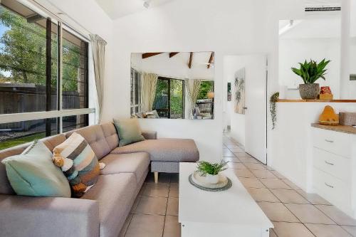 a living room with a couch and a table at Green Cottage Trinity Beach Pet friendly BBQ in Trinity Beach