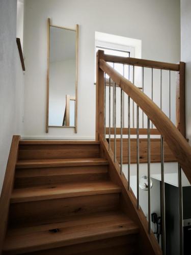 a staircase in a house with a mirror on the wall at Ferienwohnung im Panoramaweg in Rieden