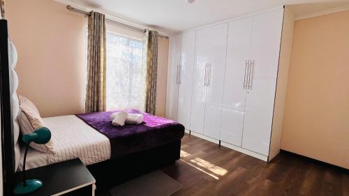 a small bedroom with a bed and a window at Khopolong Estates in Berea Hills