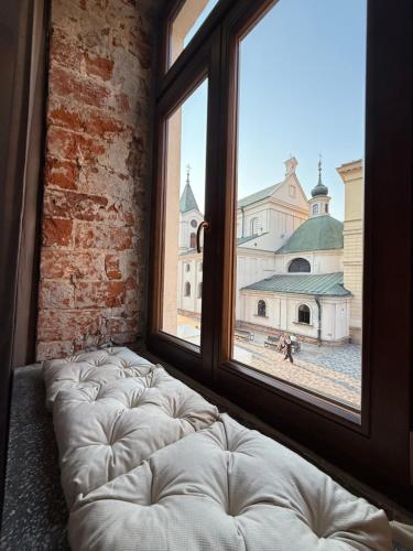 a large window with a white bed in a room at GRATIA RESIDENCE Lublin in Lublin