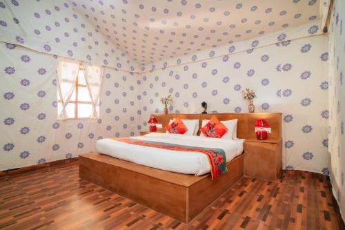 a bedroom with a bed in a room at Chokhi Dhani Desert Camp in Sām