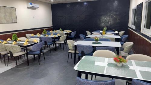 a row of tables and chairs in a restaurant at Green Paradise Hotel in Mogadishu
