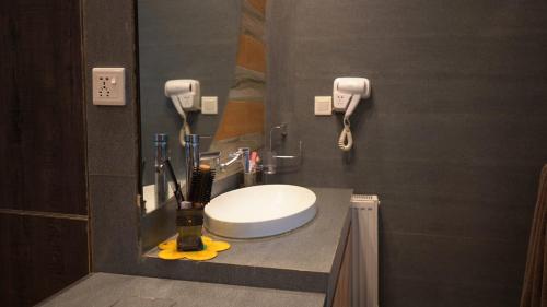 a bathroom with a sink and a mirror at Murree best apartment in Murree