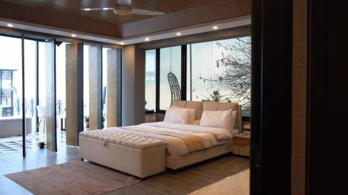 a bedroom with a large bed in a room with windows at Murree best apartment in Murree