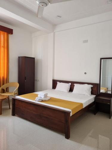 a bedroom with a large bed in a room at Wings Hotel & Hostel in Trincomalee