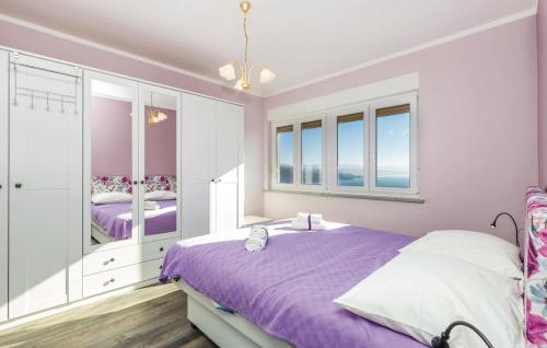 um quarto roxo e branco com uma cama e janelas em Jane Apartment em Opatija