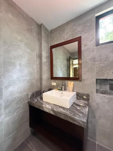 a bathroom with a white sink and a mirror at Anaya Villas Resort in Bantayan Island