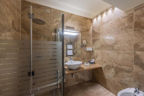 a bathroom with a sink and a shower at Garda Suite Hotel - Tonelli Hotels in Riva del Garda