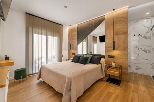 a bedroom with a large bed and a large window at Loft luxury Mirador in Cádiz