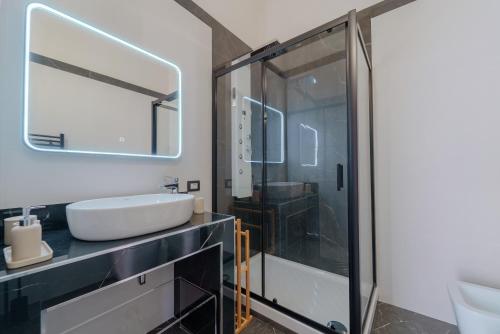 a bathroom with a glass shower and a sink at La Finestra sul Mare di Ortigia Suite Luxury in Syracuse