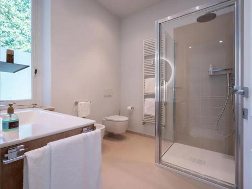 a bathroom with a shower and a sink and a toilet at Uviglie Apartments in Rosignano Monferrato