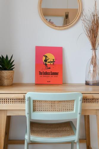 a box on a table with a blue chair at Hotel Bistrot FINE in Anglet