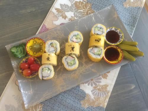 a plate of sushi and vegetables on a table at Evergreen Bed & Breakfast in Hope