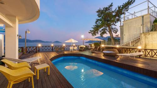 a swimming pool on the deck of a house at Namhae Opera House Pension in Namhae