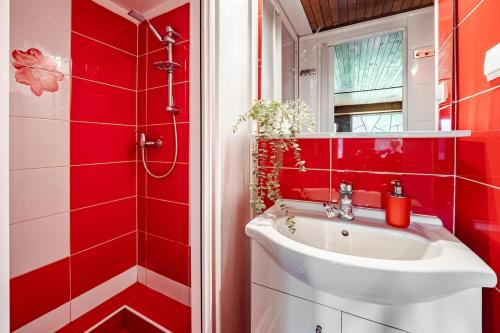 a bathroom with red walls and a white sink at Cottage Owl 