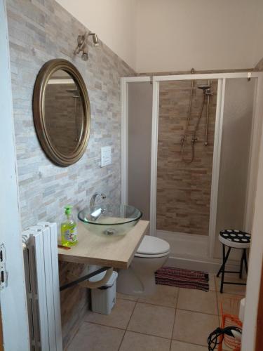 a bathroom with a sink and a toilet and a mirror at Il Gelso Casa Vacanze in Piombino
