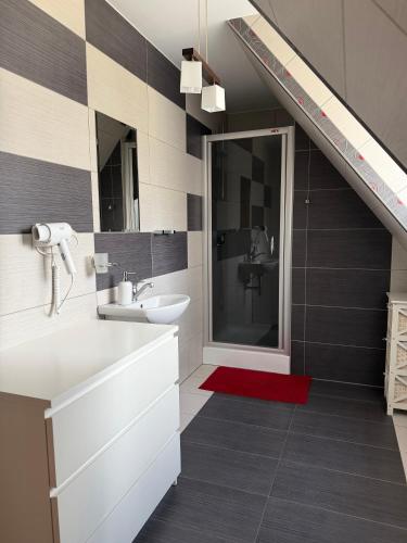 a bathroom with a sink and a staircase at Apartament u SKOCZKA in Poronin