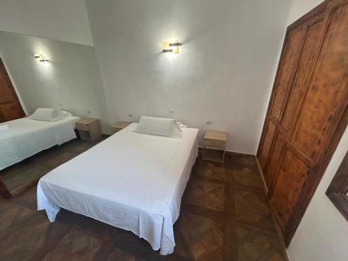 a bedroom with two beds and a wooden door at Malibu Ocean View in Adeje